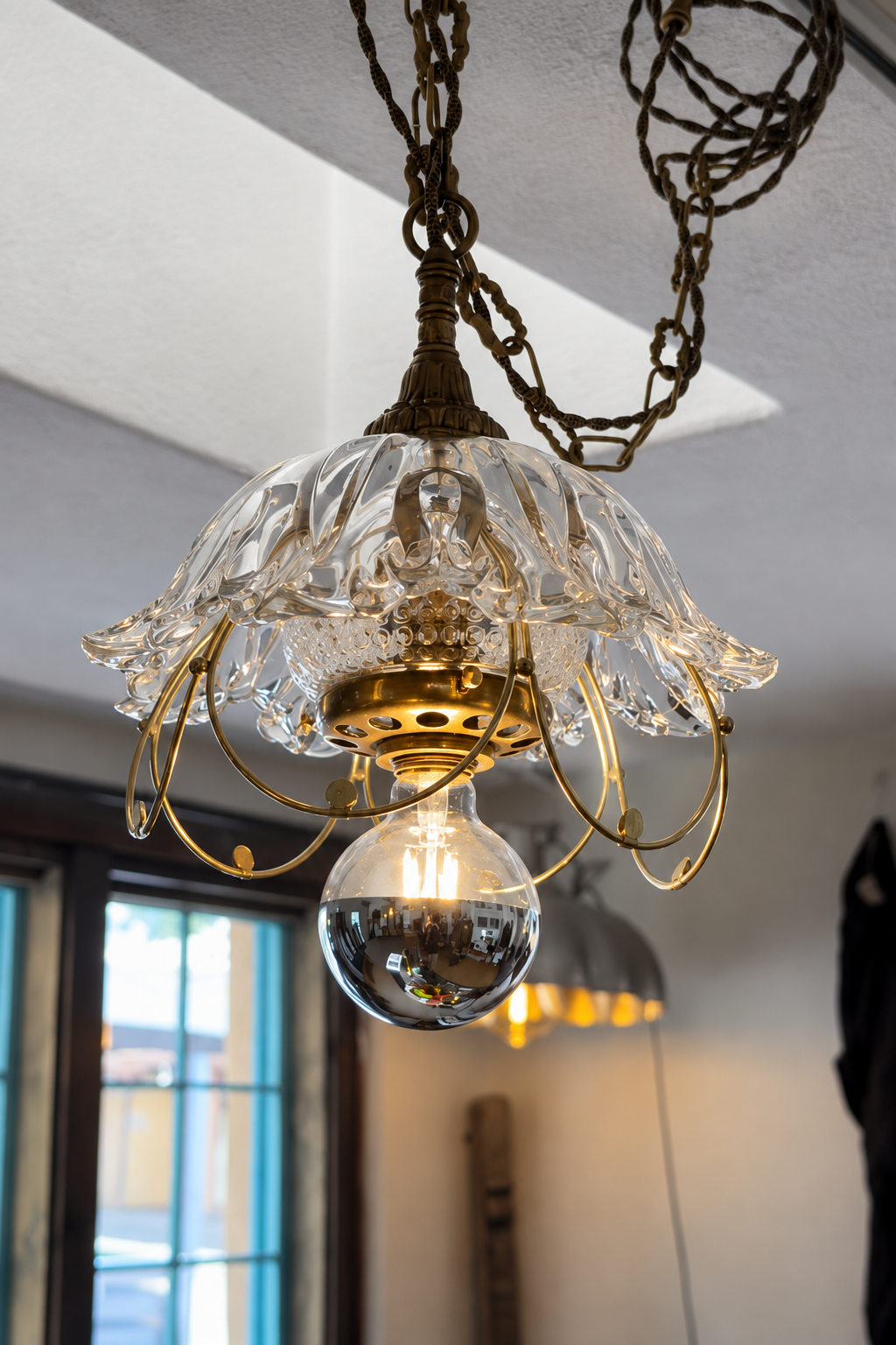 Underside of bespoke assembled pendant light with reflective bulb